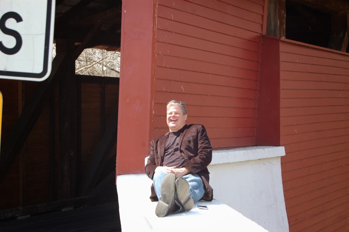 Ken laughing by red barn