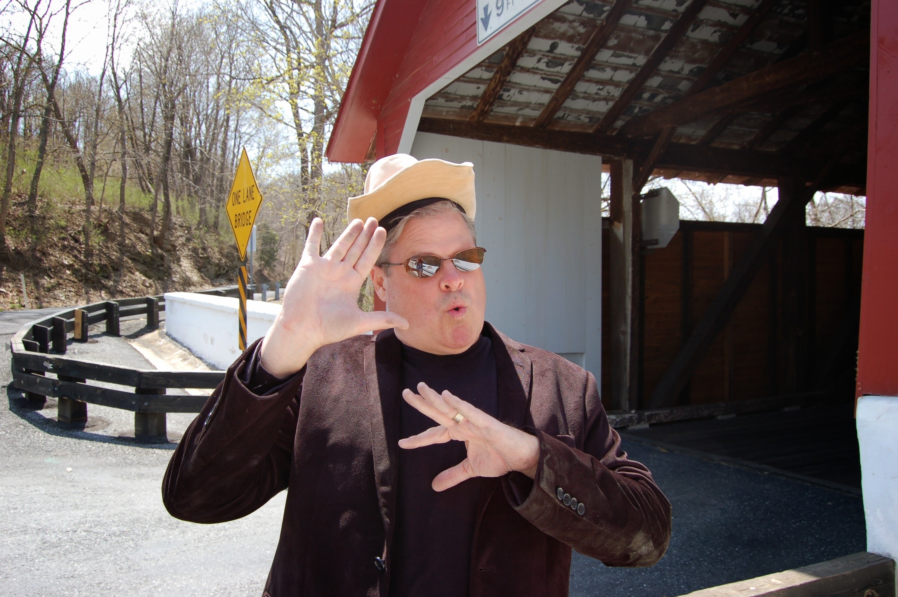 Ken in cowboy hat at covered bridge