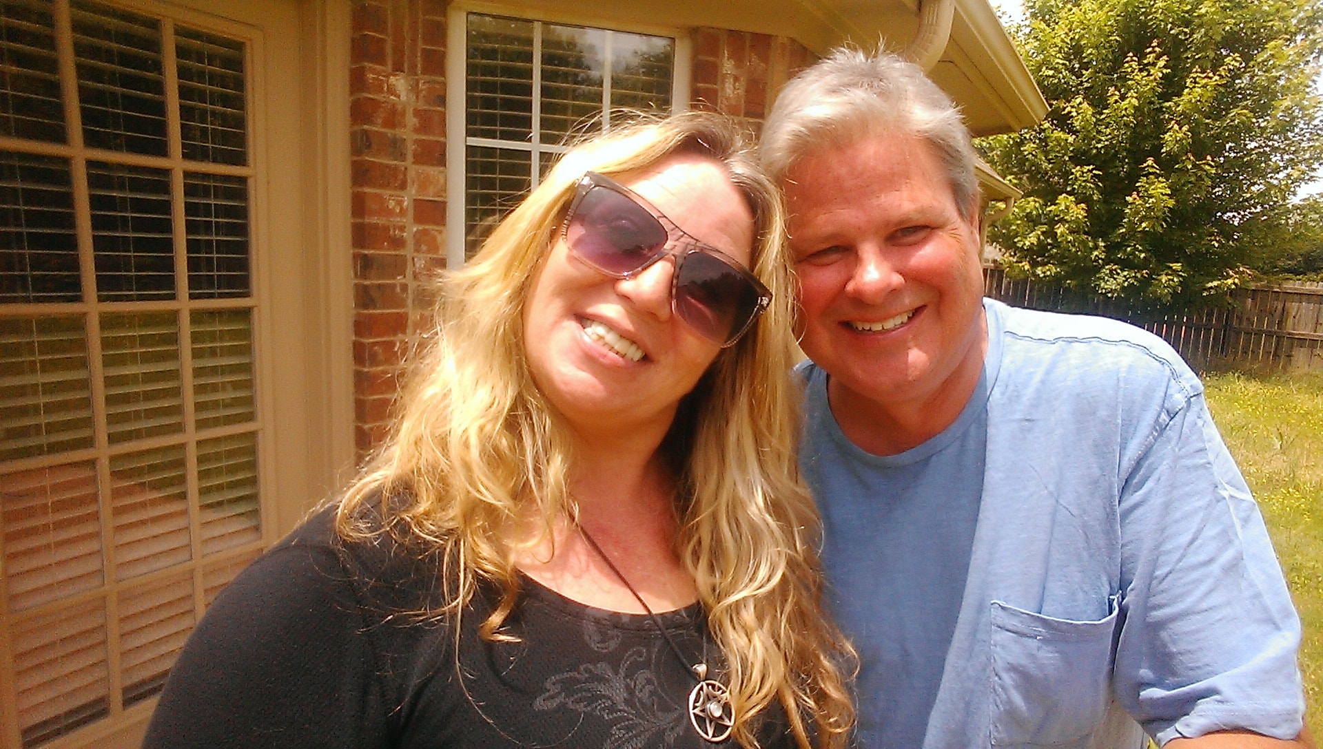 Ken and Kitty smiling together outdoors
