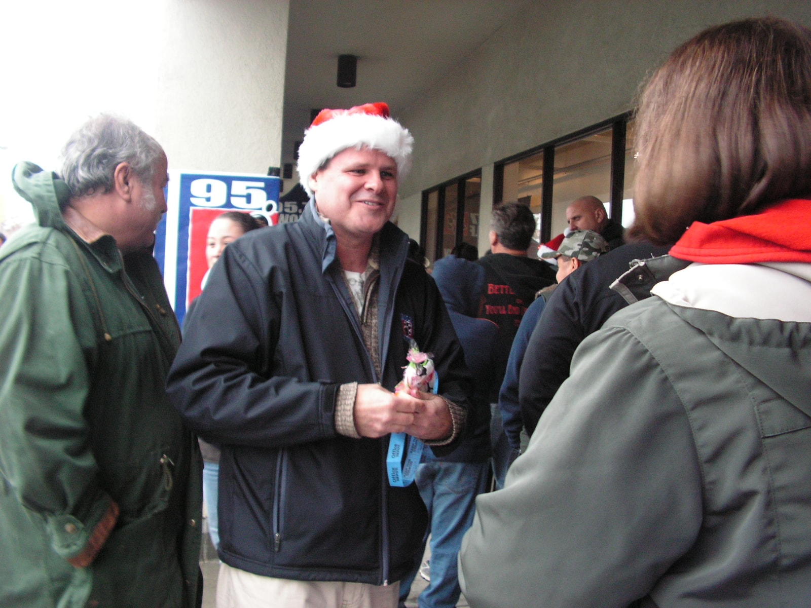 Ken in Santa hat meeting fans at holiday radio event